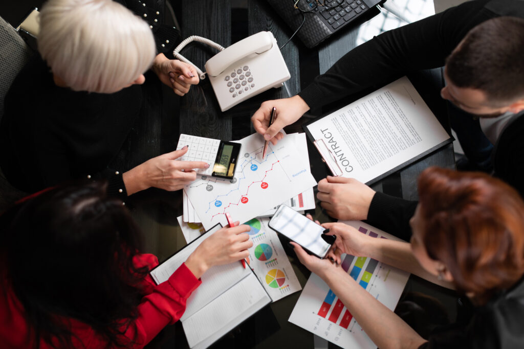 a group of professionals optimizing marketing operations at a table